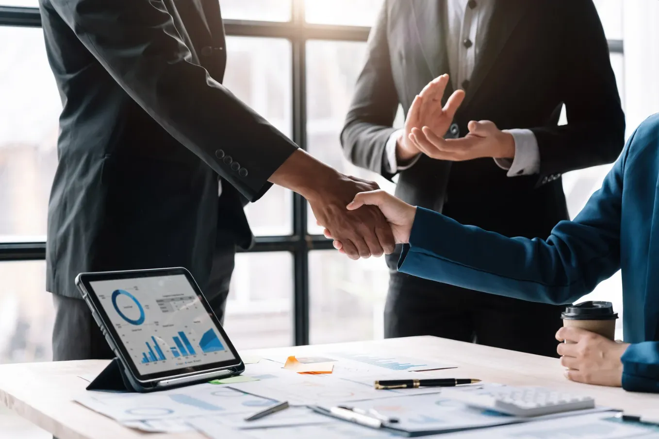 Businessmen in suits shaking hands